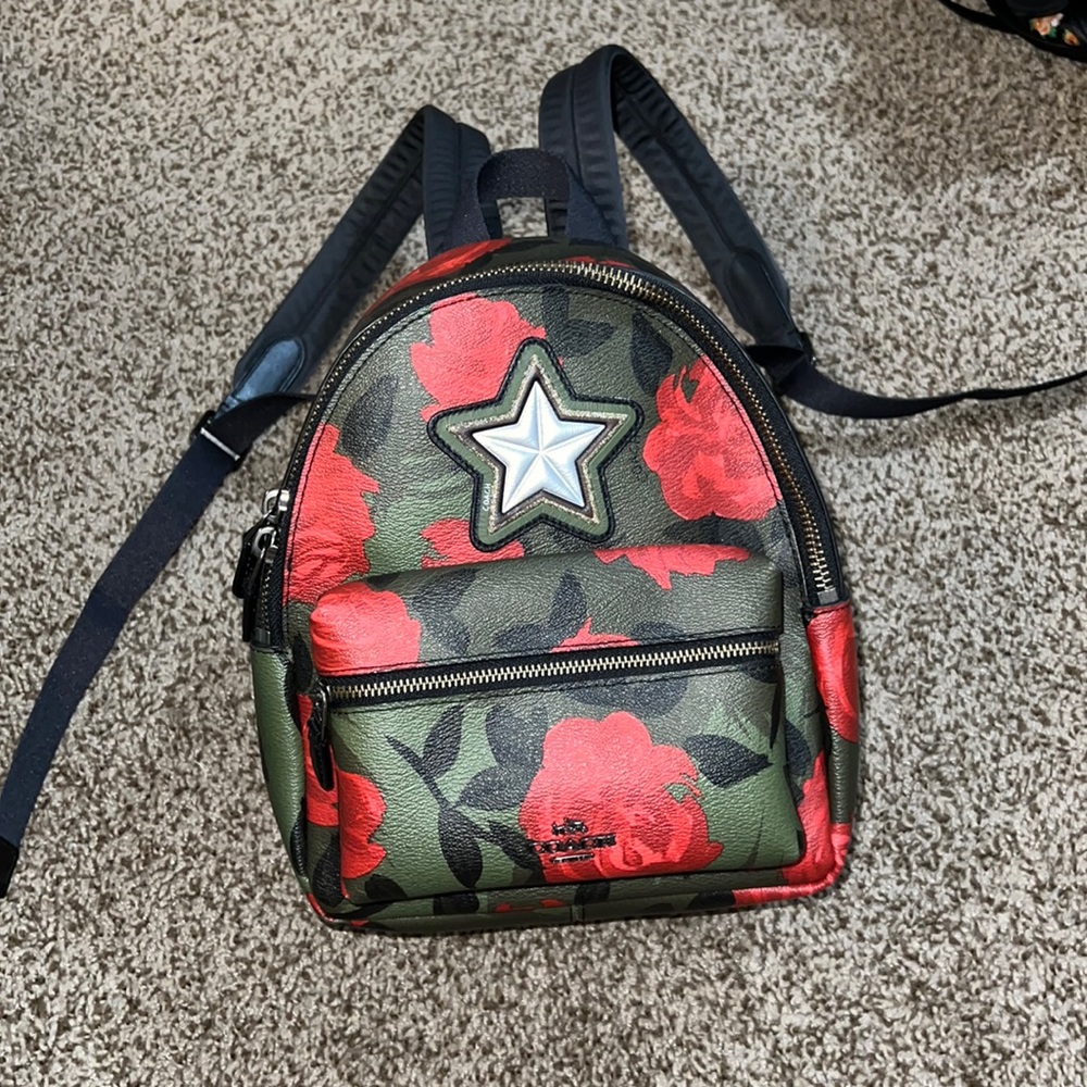 Coach mini backpack camo and roses print.